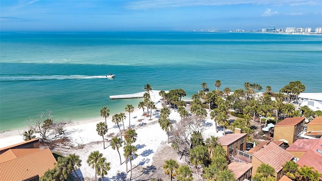 birds eye view of property featuring a beach view and a water view