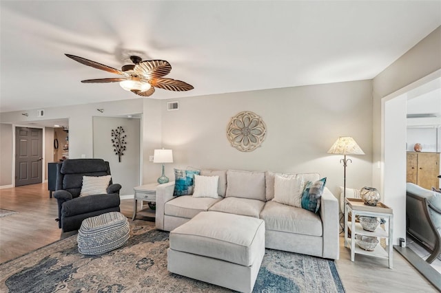 living room featuring ceiling fan and light hardwood / wood-style floors