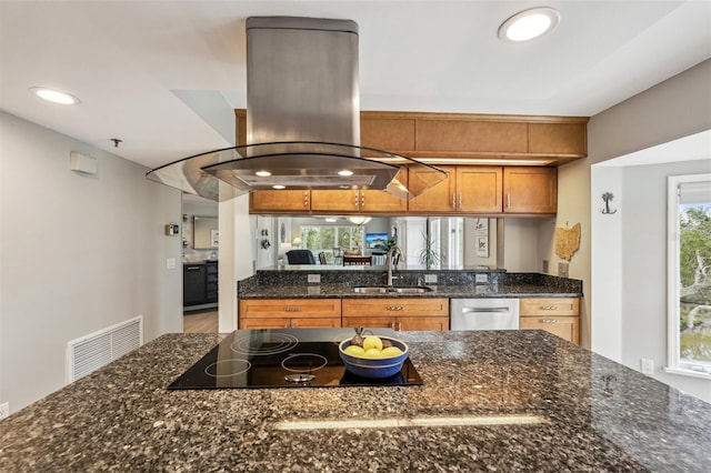 kitchen featuring sink, island range hood, black electric cooktop, dishwasher, and dark stone counters