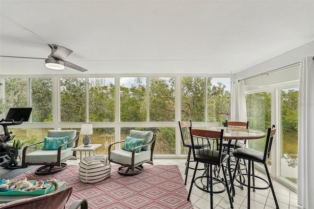 sunroom / solarium featuring ceiling fan