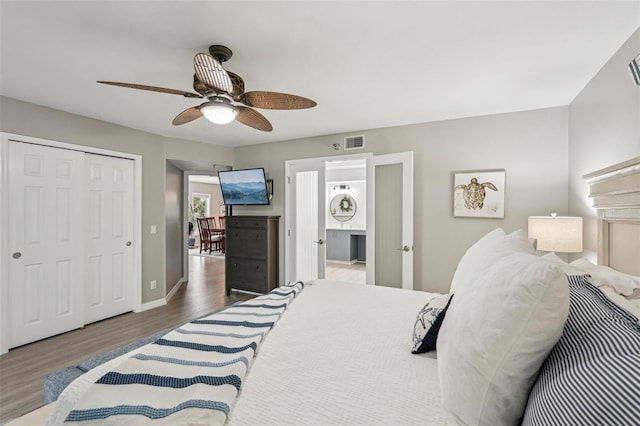 bedroom with ceiling fan, dark hardwood / wood-style flooring, and a closet