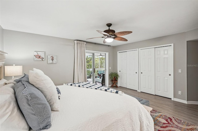 bedroom with multiple closets, wood-type flooring, access to outside, and ceiling fan