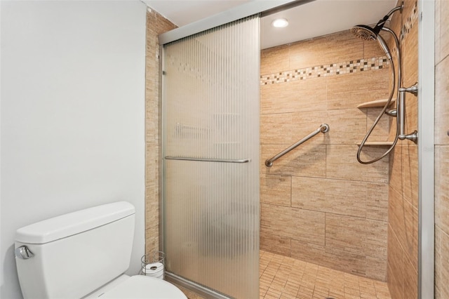 bathroom featuring an enclosed shower and toilet