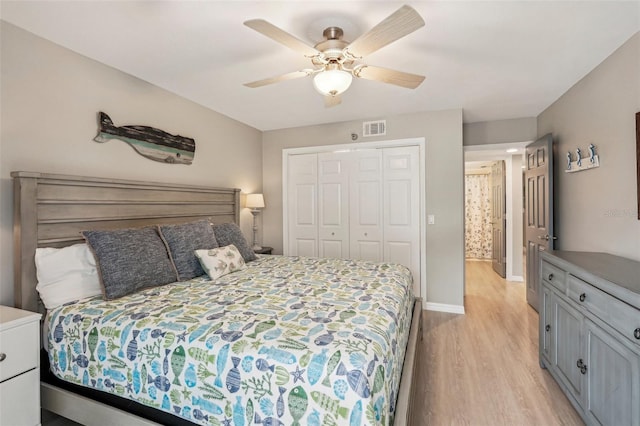 bedroom featuring ceiling fan, light wood-type flooring, and a closet