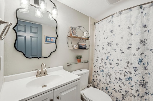 bathroom featuring vanity, a shower with shower curtain, and toilet