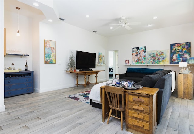 living room with ceiling fan and light wood-type flooring