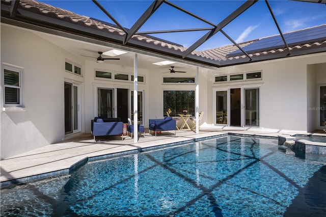 view of swimming pool featuring an in ground hot tub, glass enclosure, ceiling fan, and a patio area