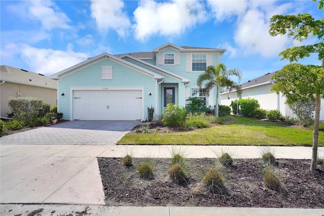 view of front of property featuring a garage and a front yard