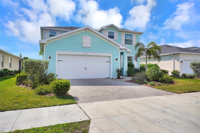 view of front facade with a garage and a front lawn