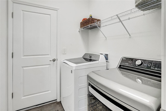 clothes washing area featuring separate washer and dryer