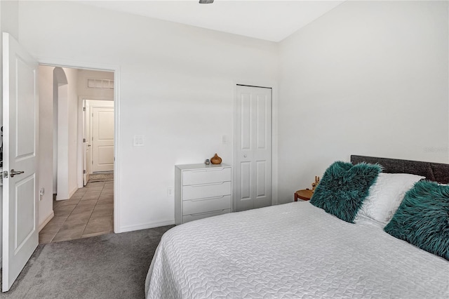 carpeted bedroom with a closet