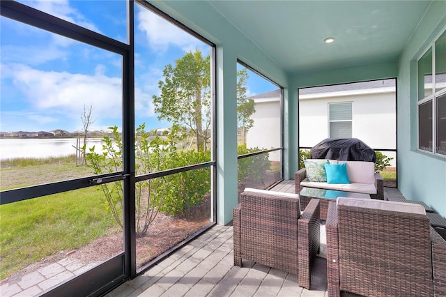 sunroom / solarium featuring a water view