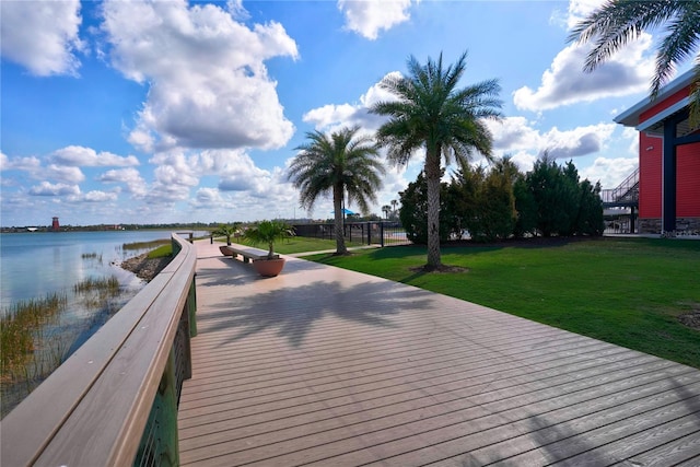 view of dock featuring a water view and a lawn