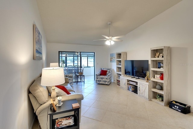 living room featuring ceiling fan, lofted ceiling, and light tile patterned floors