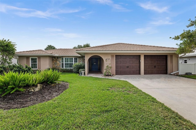 view of front of home with a garage and a front lawn