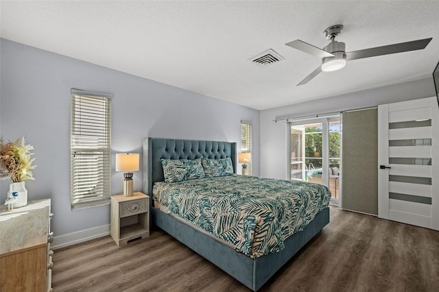 bedroom with ceiling fan, dark wood-type flooring, access to outside, and a textured ceiling