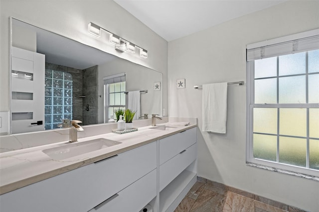 bathroom with vanity and a shower