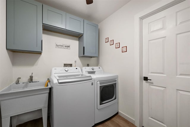 laundry room featuring sink, washer and clothes dryer, ceiling fan, cabinets, and dark hardwood / wood-style flooring