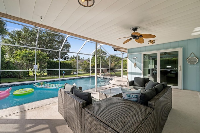 view of swimming pool featuring an outdoor living space, a lanai, a patio area, and ceiling fan