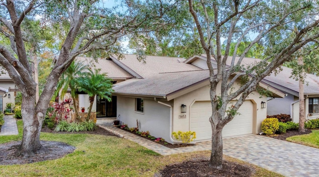 view of front of house with a garage and a front yard