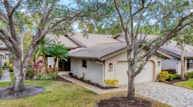 view of front of house with a garage and a front yard