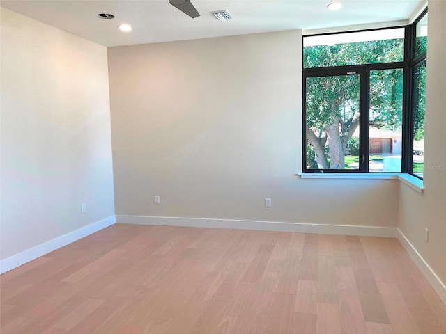 unfurnished room featuring light wood-style flooring, recessed lighting, visible vents, and baseboards