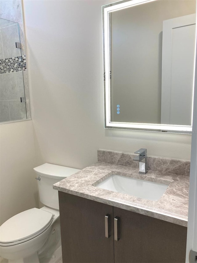 bathroom featuring vanity and toilet