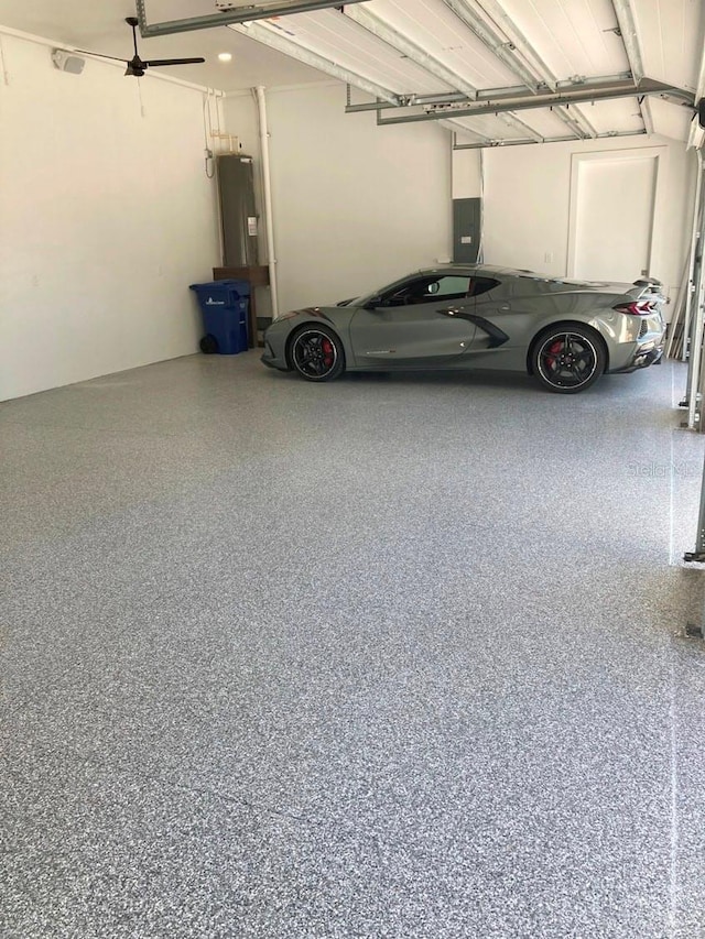 garage featuring electric panel and electric water heater