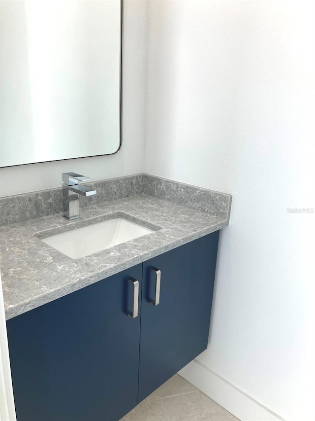 bathroom featuring tile patterned flooring and vanity