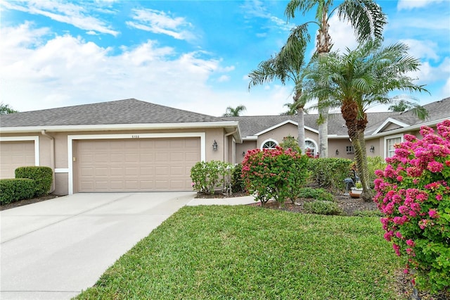 single story home featuring a garage and a front yard