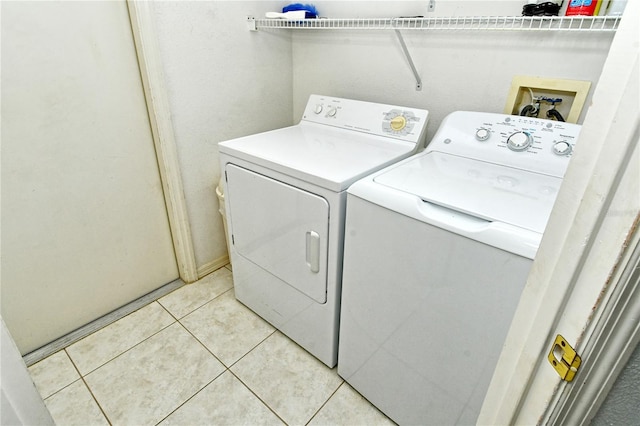 washroom featuring independent washer and dryer and light tile patterned floors