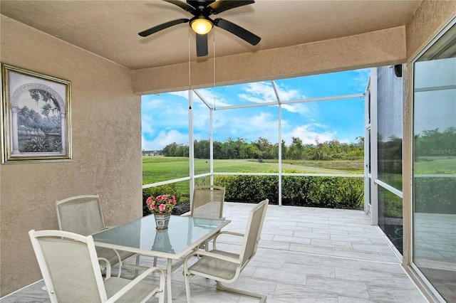 sunroom featuring ceiling fan