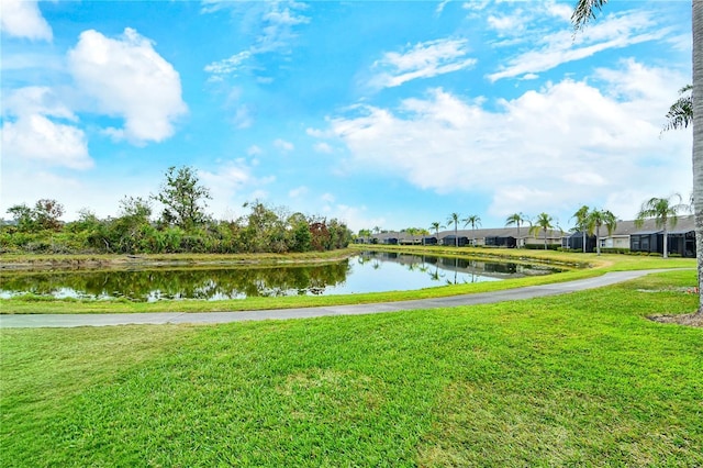 view of community featuring a water view and a lawn