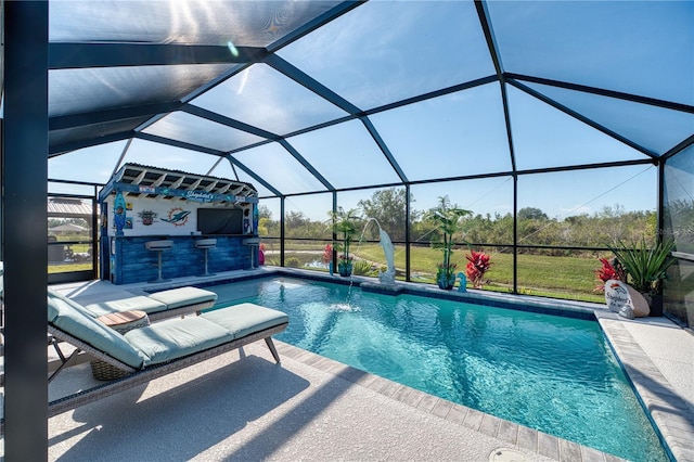 view of swimming pool featuring a patio, a lanai, exterior bar, and pool water feature