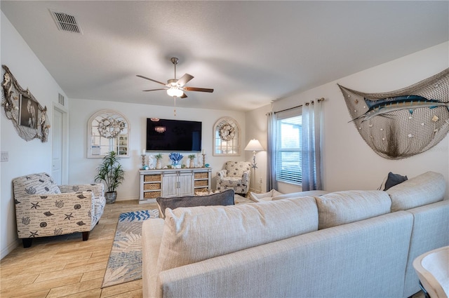 living room featuring ceiling fan and light hardwood / wood-style flooring