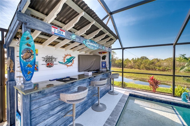 view of patio / terrace with an outdoor bar and glass enclosure