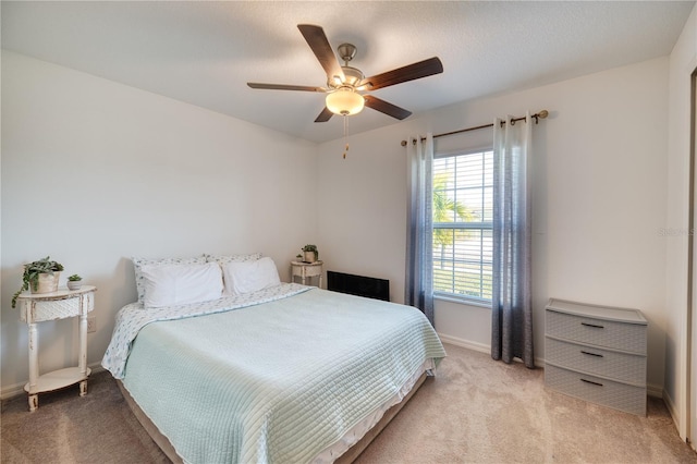 bedroom with ceiling fan and light colored carpet