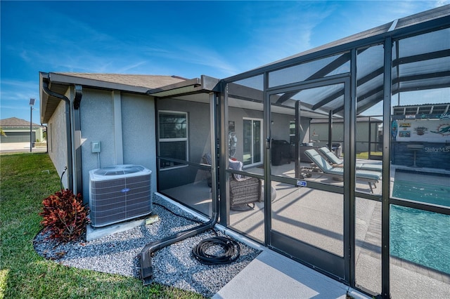 exterior space with cooling unit, a lanai, and a patio