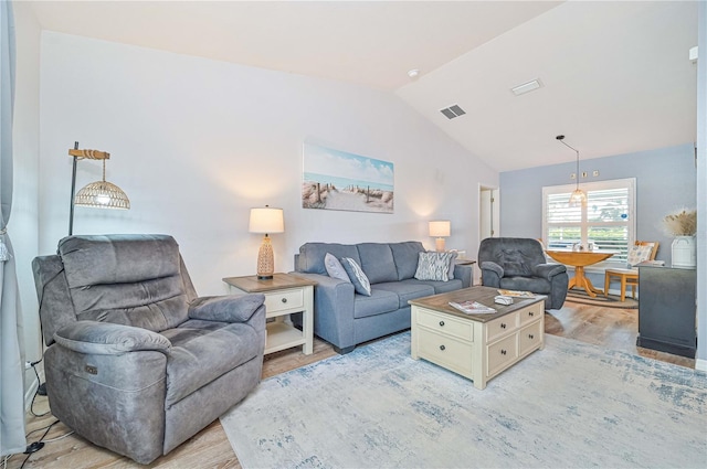 living room with lofted ceiling and light hardwood / wood-style floors