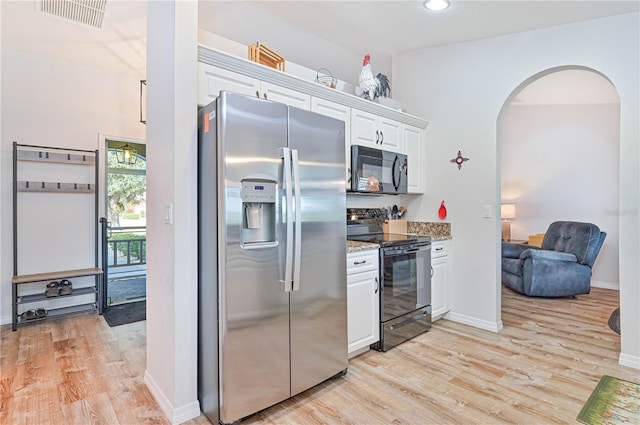 kitchen featuring white cabinetry, light stone countertops, light wood-type flooring, and black appliances