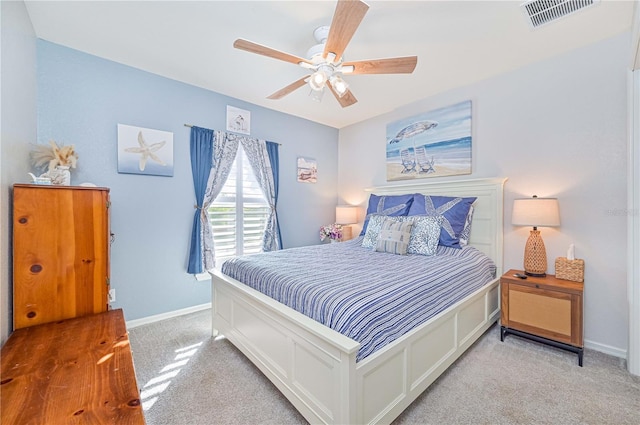 bedroom featuring light colored carpet and ceiling fan