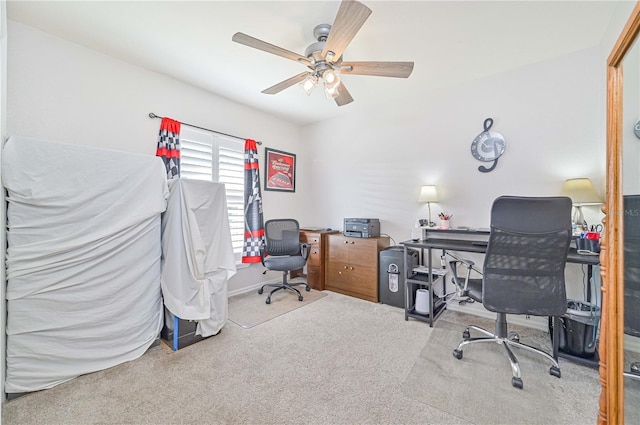 carpeted office space with ceiling fan