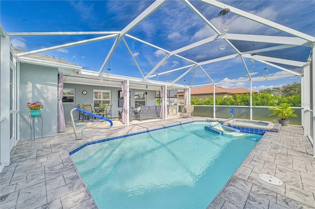 view of pool with an in ground hot tub, a lanai, and a patio