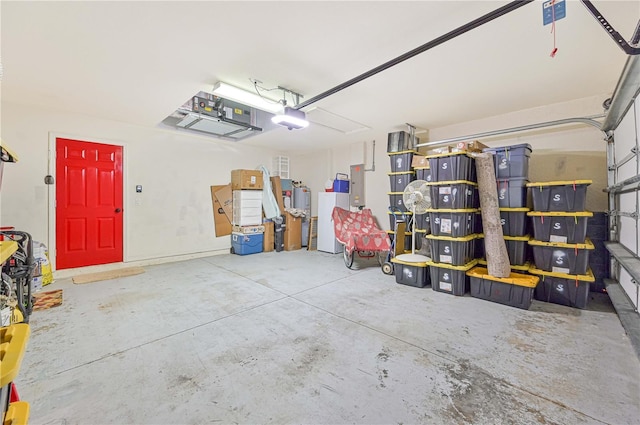 garage with a garage door opener and electric panel