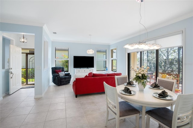 dining room with crown molding, a wealth of natural light, and light tile patterned flooring