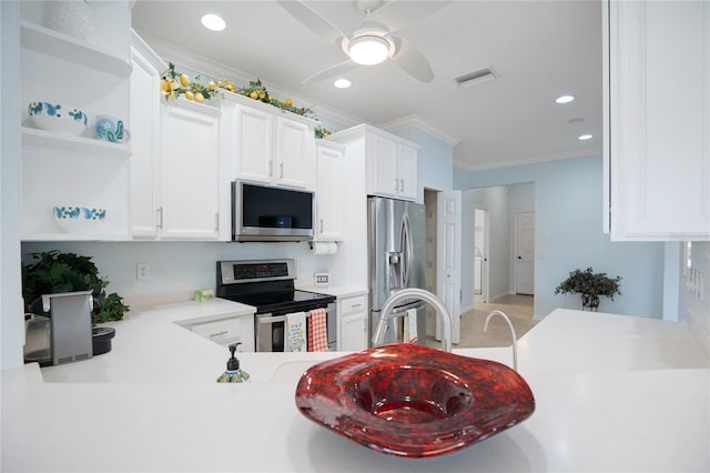 kitchen featuring ceiling fan, ornamental molding, white cabinets, and appliances with stainless steel finishes