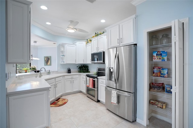 kitchen featuring white cabinetry, appliances with stainless steel finishes, crown molding, and sink