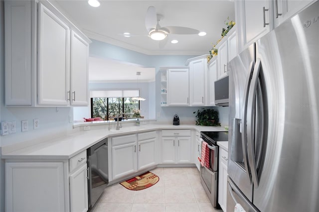 kitchen featuring hanging light fixtures, light tile patterned floors, ornamental molding, appliances with stainless steel finishes, and white cabinets