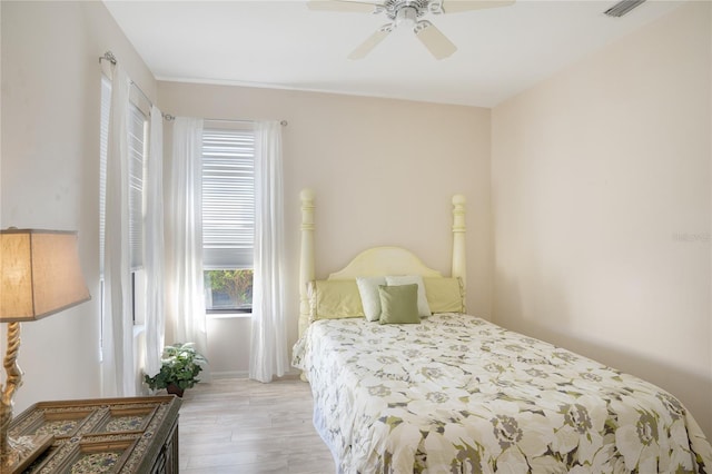 bedroom with ceiling fan and light hardwood / wood-style floors