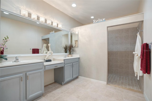 bathroom featuring tiled shower, vanity, and tile patterned floors